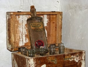 clear glass alcohol bottles with wooden storage thumbnail