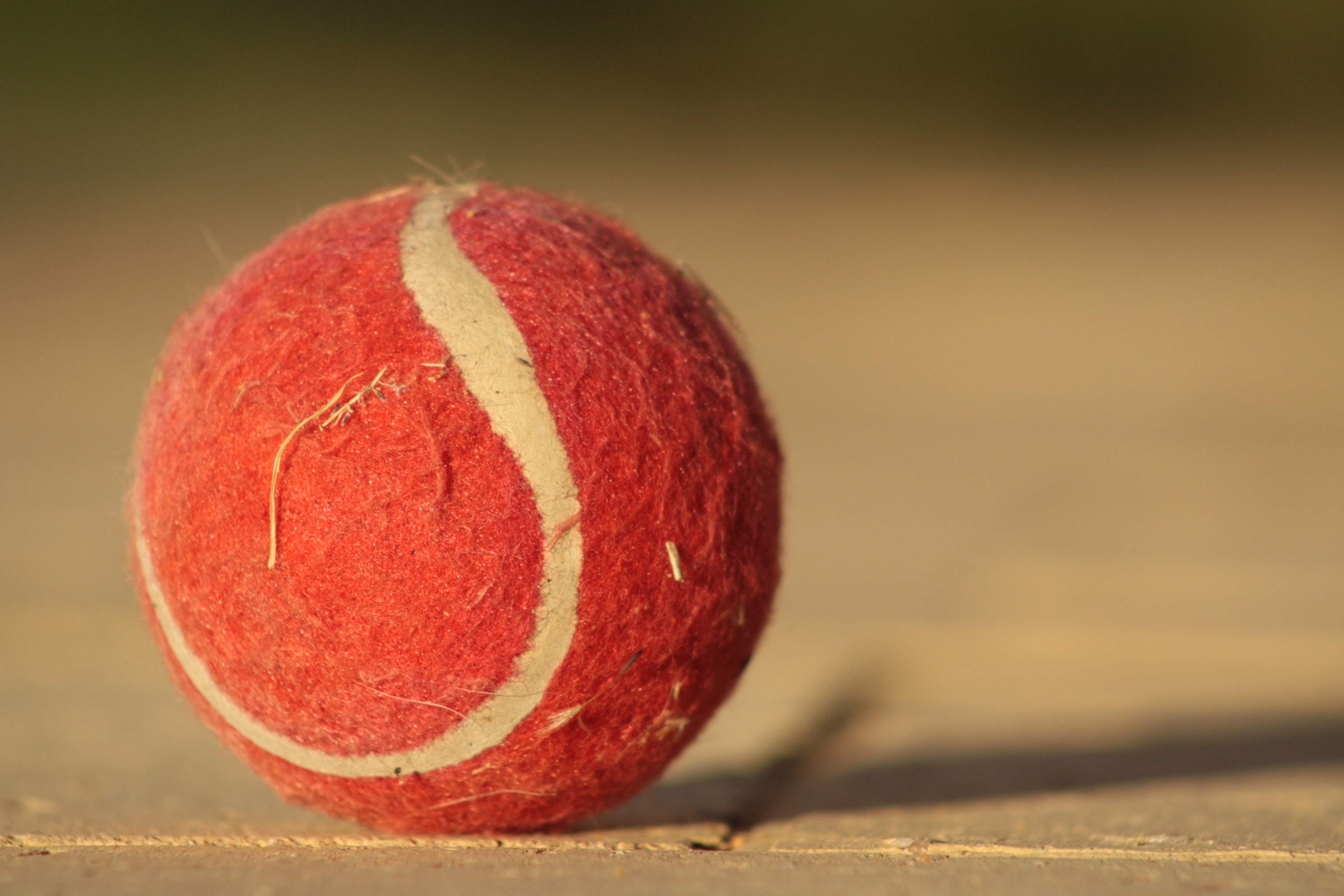 red and white tennis ball