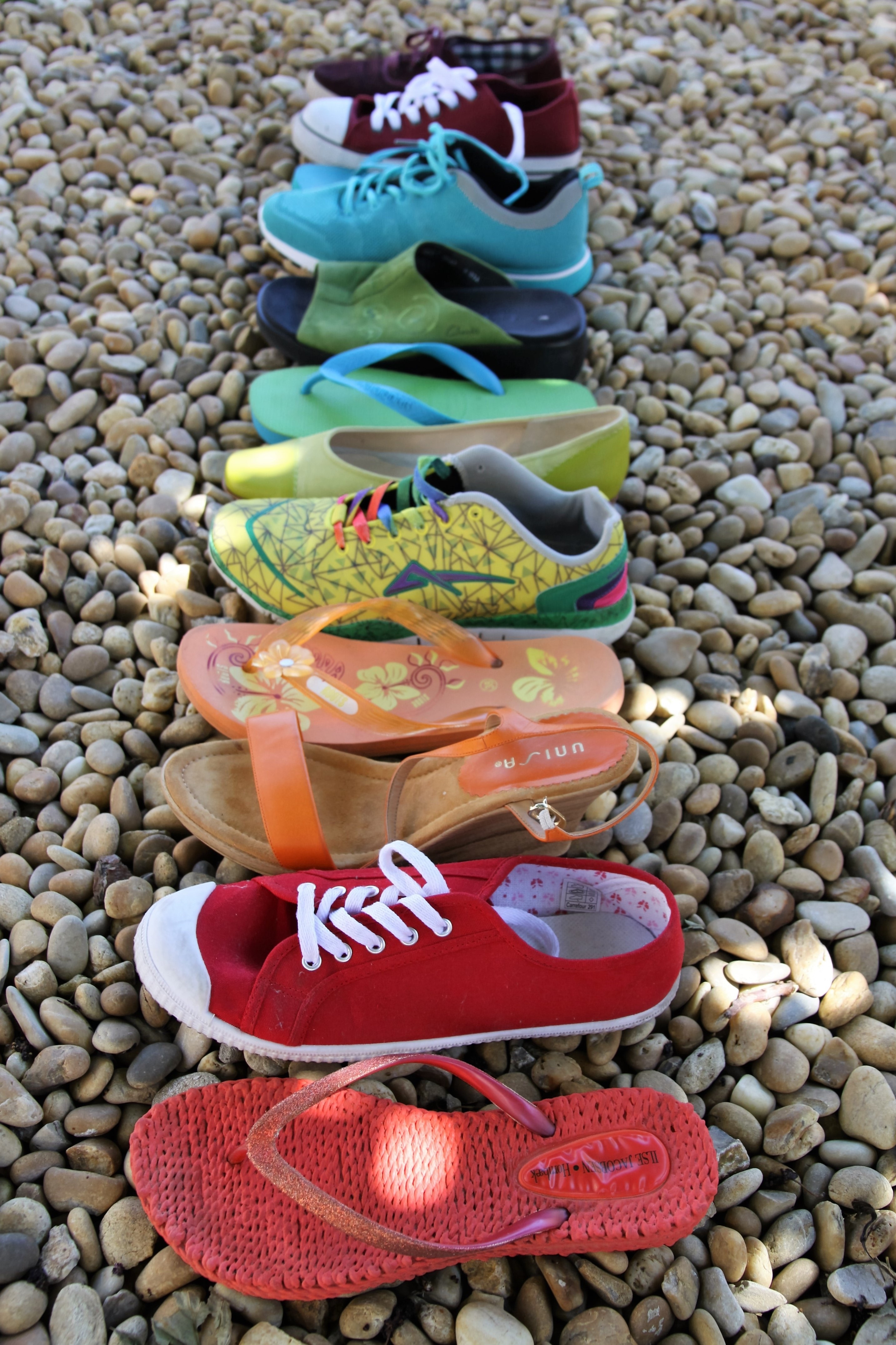 unpaired sneakers sandals and flip flops