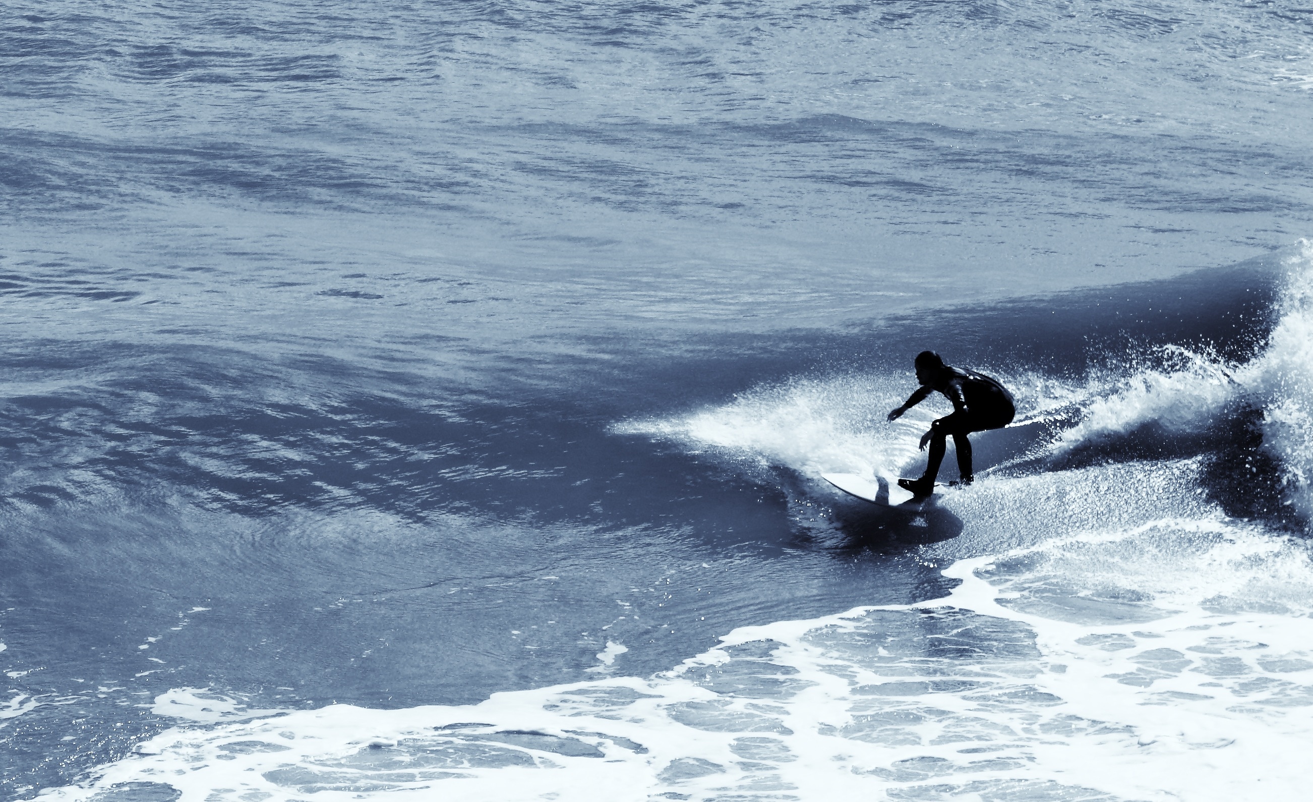 black wet suit and white surfboard
