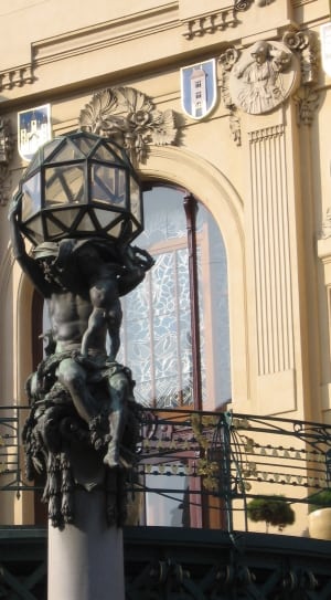 man holding lamp statue thumbnail