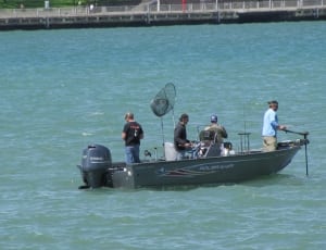 people standing on motorboat fishing thumbnail