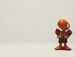 brown figure toy on white surface thumbnail