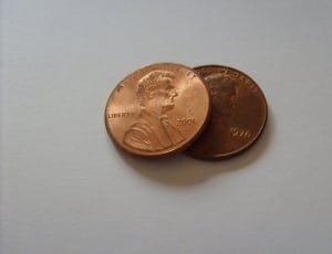 two gold man's profile round coins thumbnail