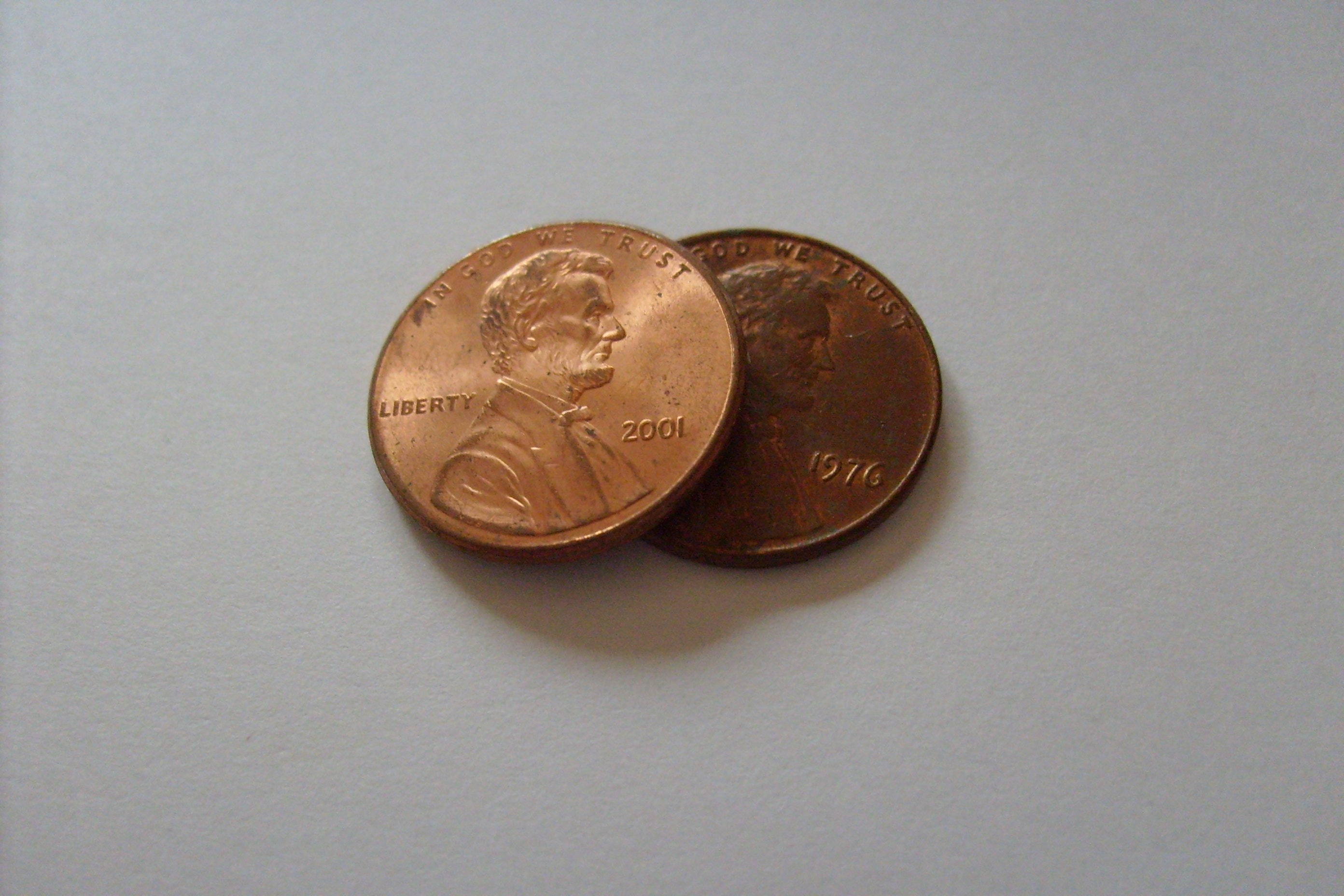 two gold man's profile round coins