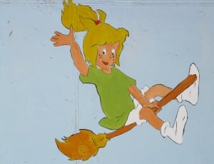 girl in green t shirt riding broom illustration thumbnail