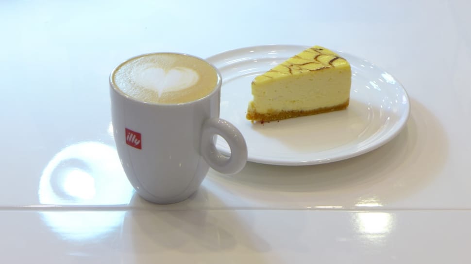 white and yellow sliced cake on white ceramic plate with white ceramic coffee mug preview