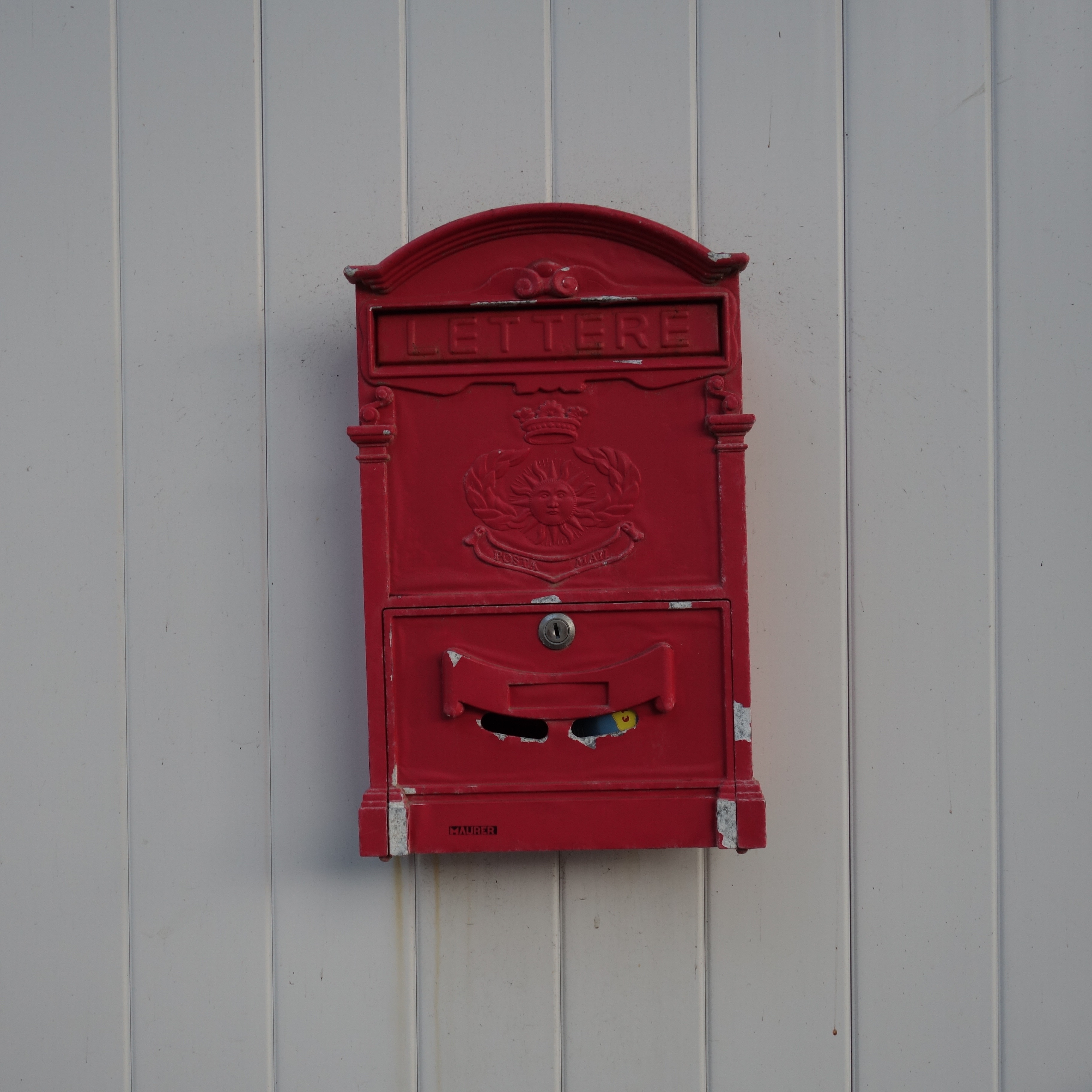 red metal wall mount mailbox