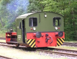 red and green train on rail thumbnail