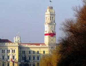 white and brown building with tower clock thumbnail