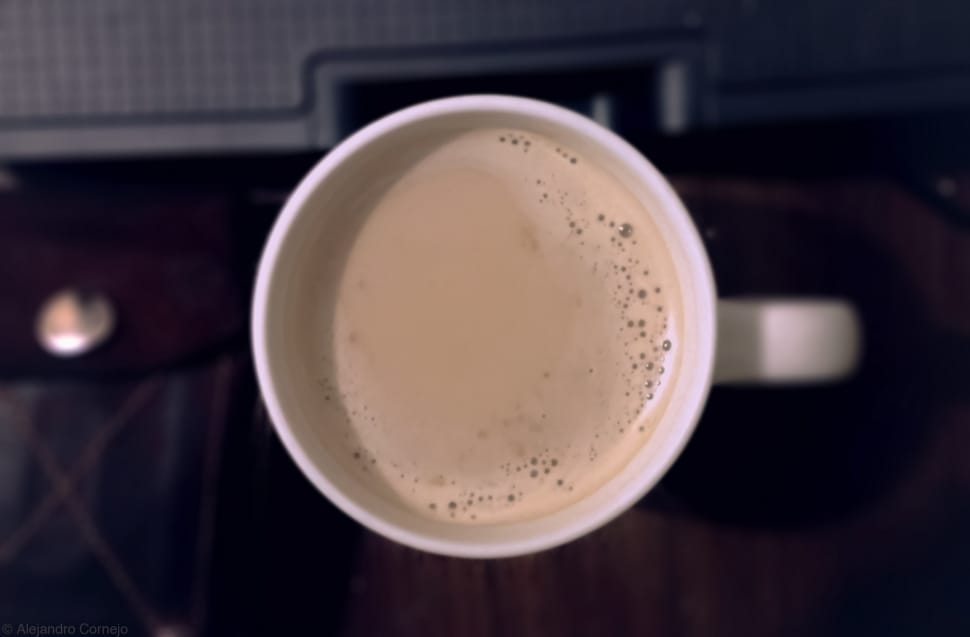 white disposable cup with brown coffee preview
