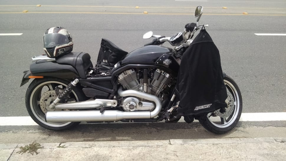 black cruiser motorcycle near asphalted road during daytime preview
