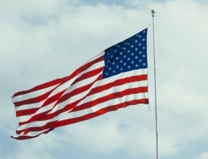 u.s. flag in pole under white cloudy sky thumbnail