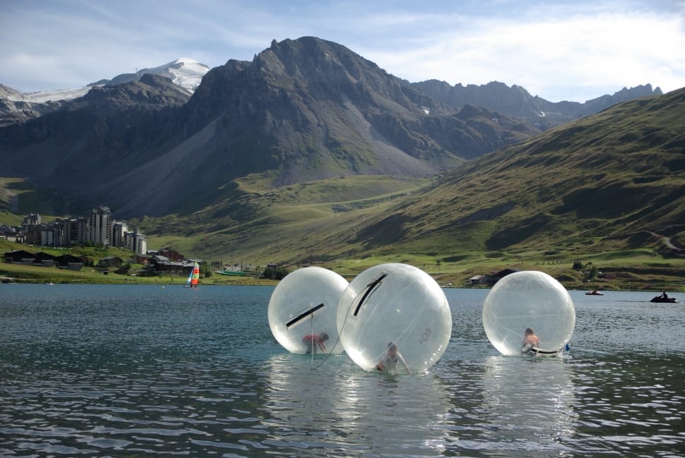 three three water ball on body of water during daytime preview