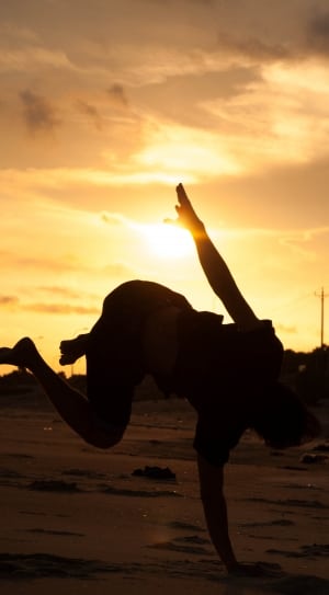 silhouette of person on sand during golden hour thumbnail