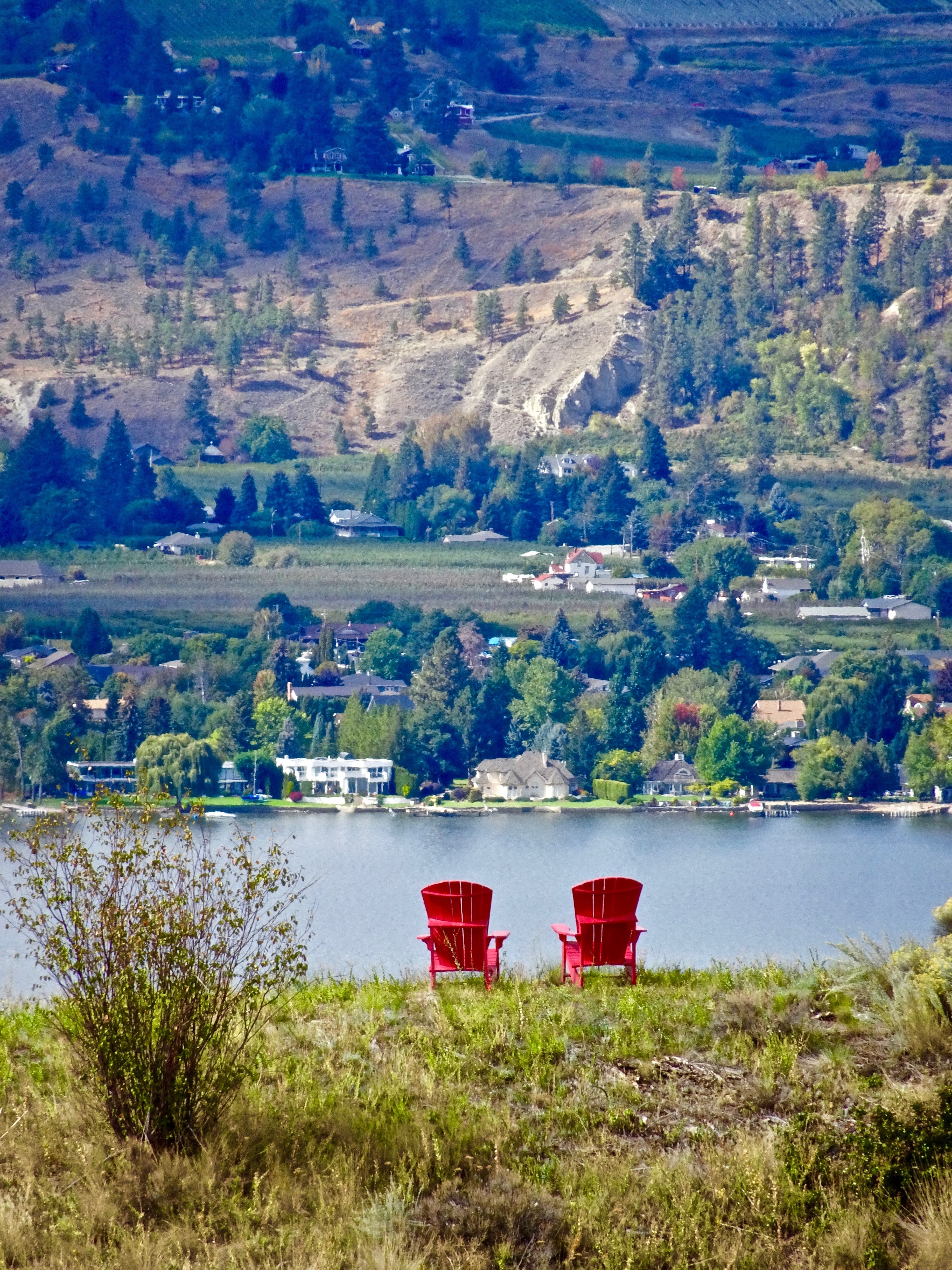 red wooden adirondack chairs