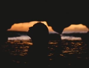 silhouette photography of woman in sea thumbnail