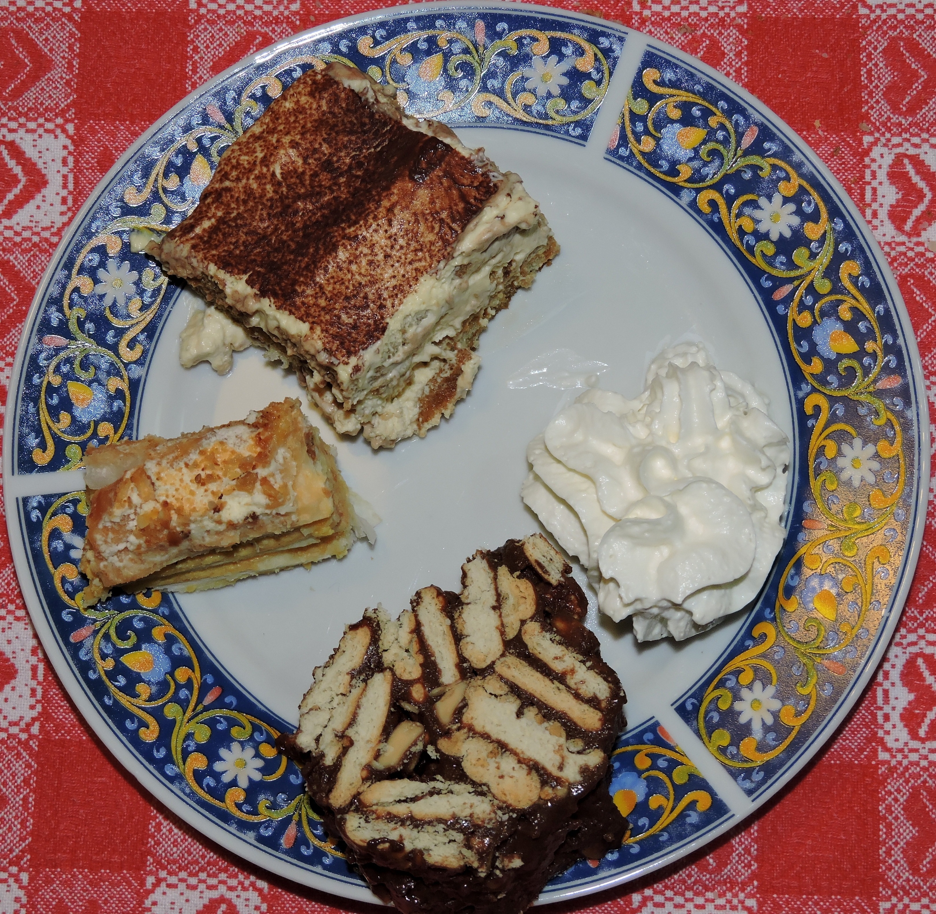 white whip cream and chocolate bars on white and blue ceramic round plate