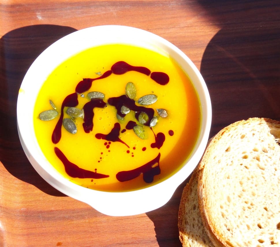 soup on white plastic bowl with bread preview