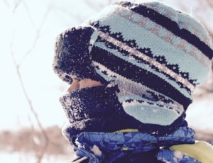close up photo of person wearing snow jacket and cap during daytime thumbnail