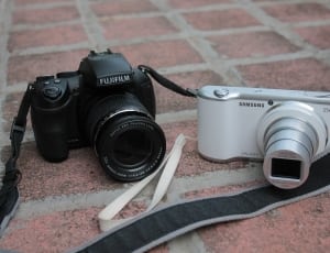 two black Fujifilm and white Samsung cameras thumbnail