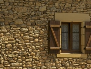 brown wooden window and stone brick wall thumbnail