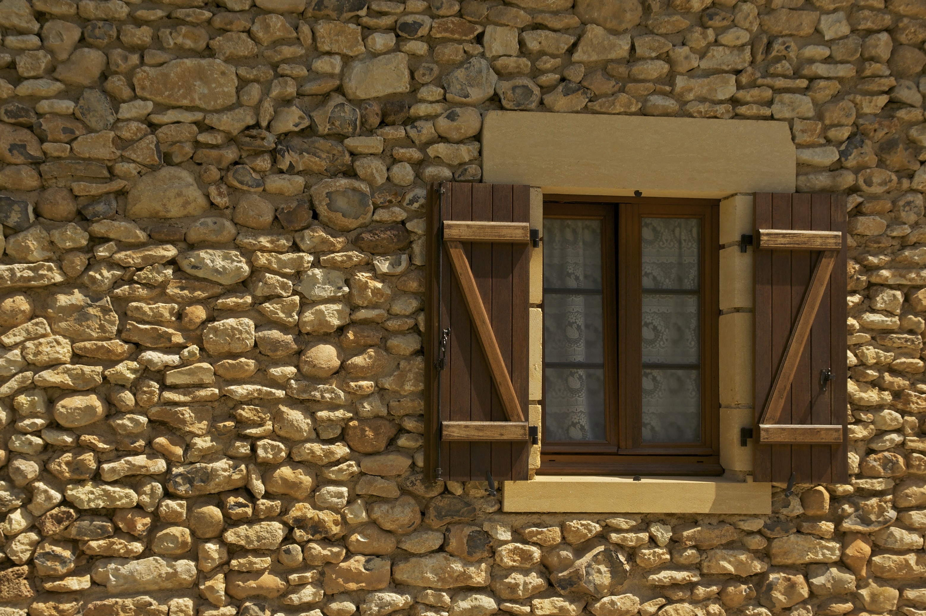 brown wooden window and stone brick wall