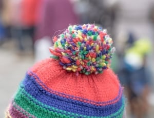red blue and green pom pom hat thumbnail