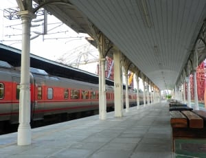 red and gray train and platform during daytime thumbnail