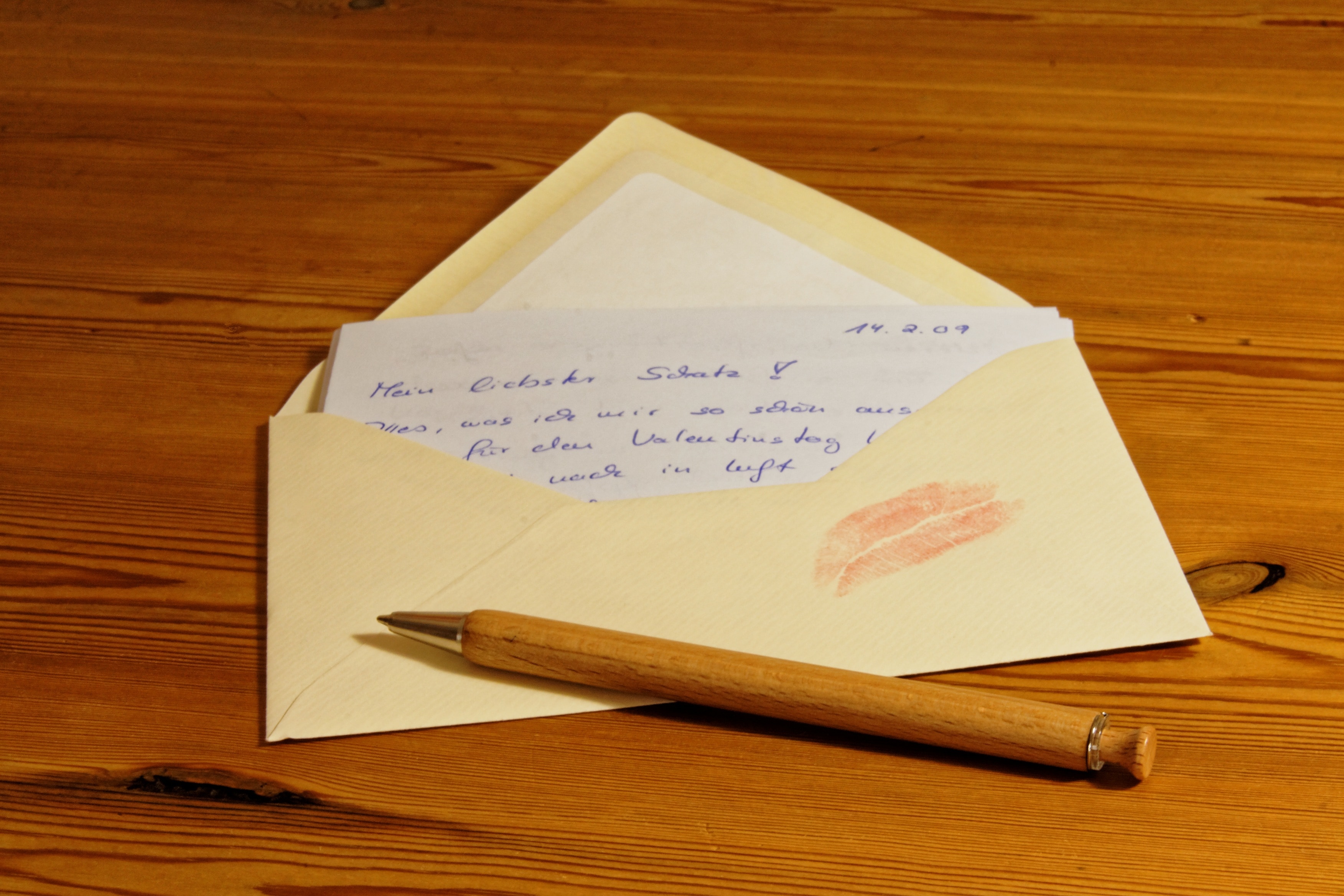brown case pen on envelop with lip mark