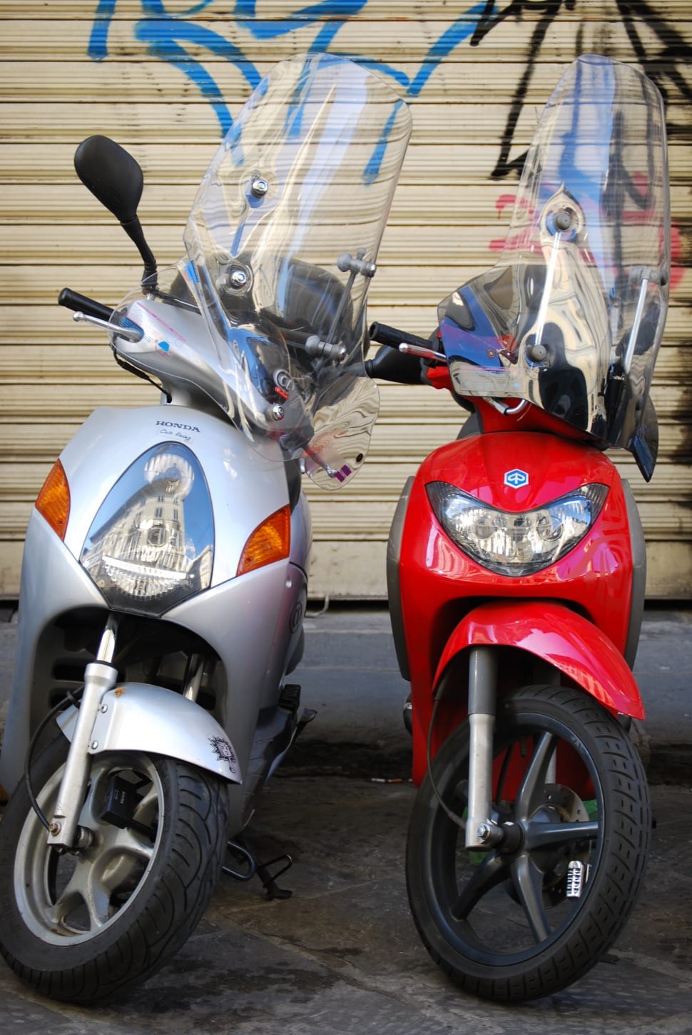 red and silver motor scooters preview