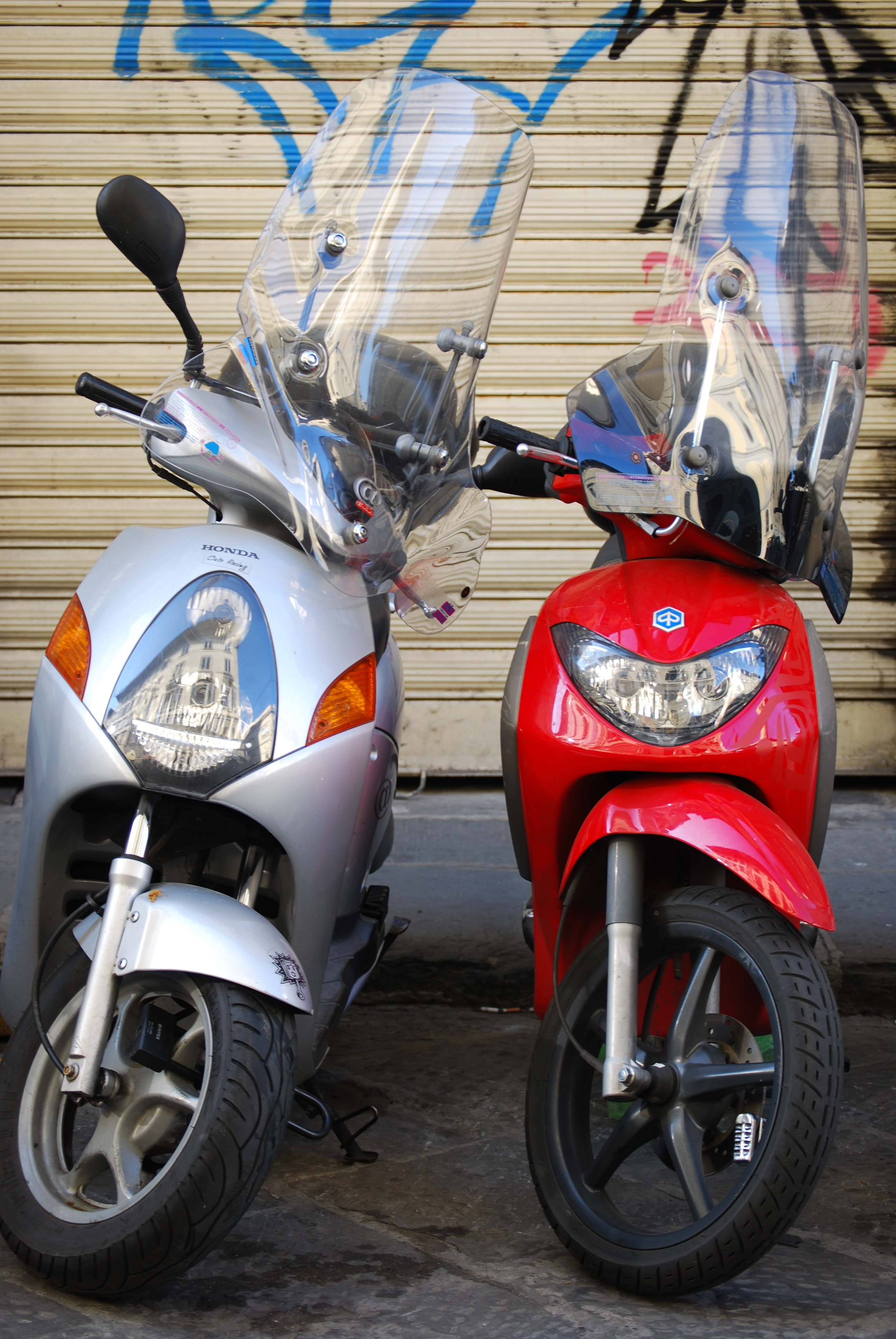 red and silver motor scooters