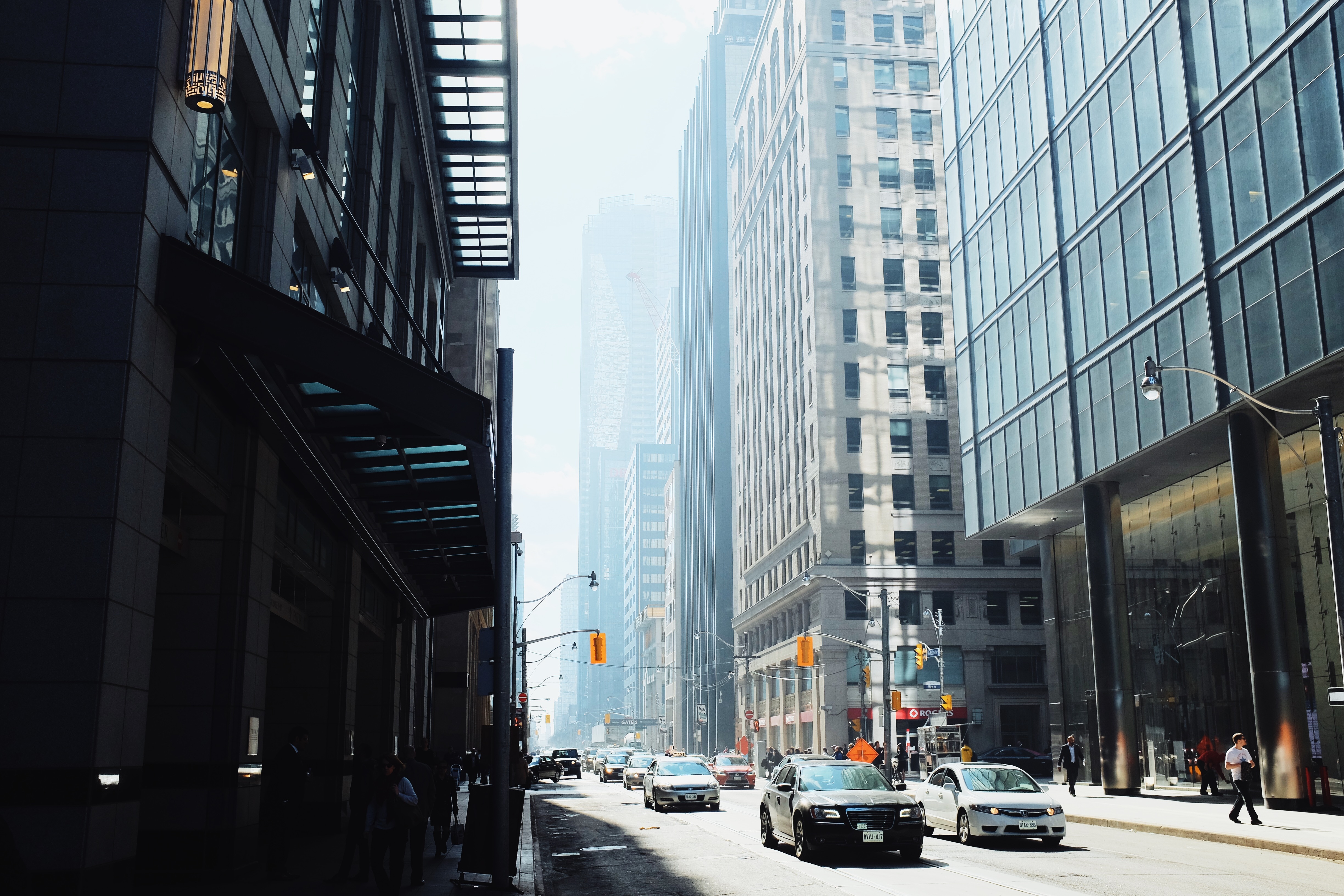 vehicles in front of high rise buildings during daytime