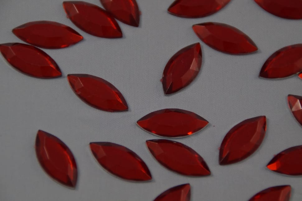 red gemstones on white textile preview