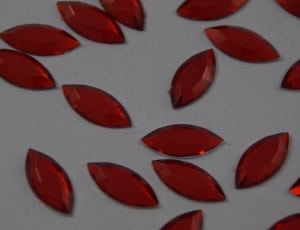 red gemstones on white textile thumbnail