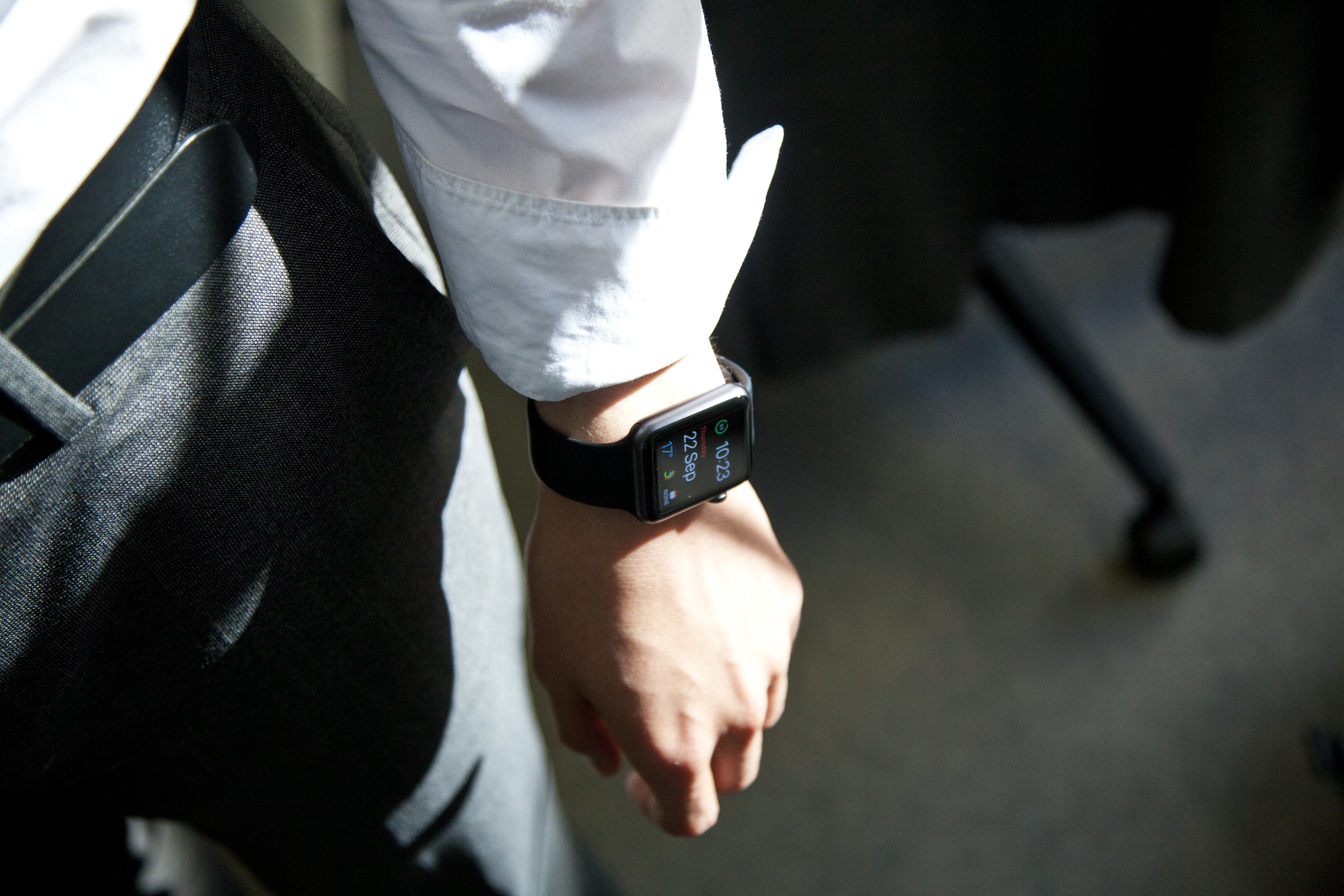 person in white dress shirt with smartwatch