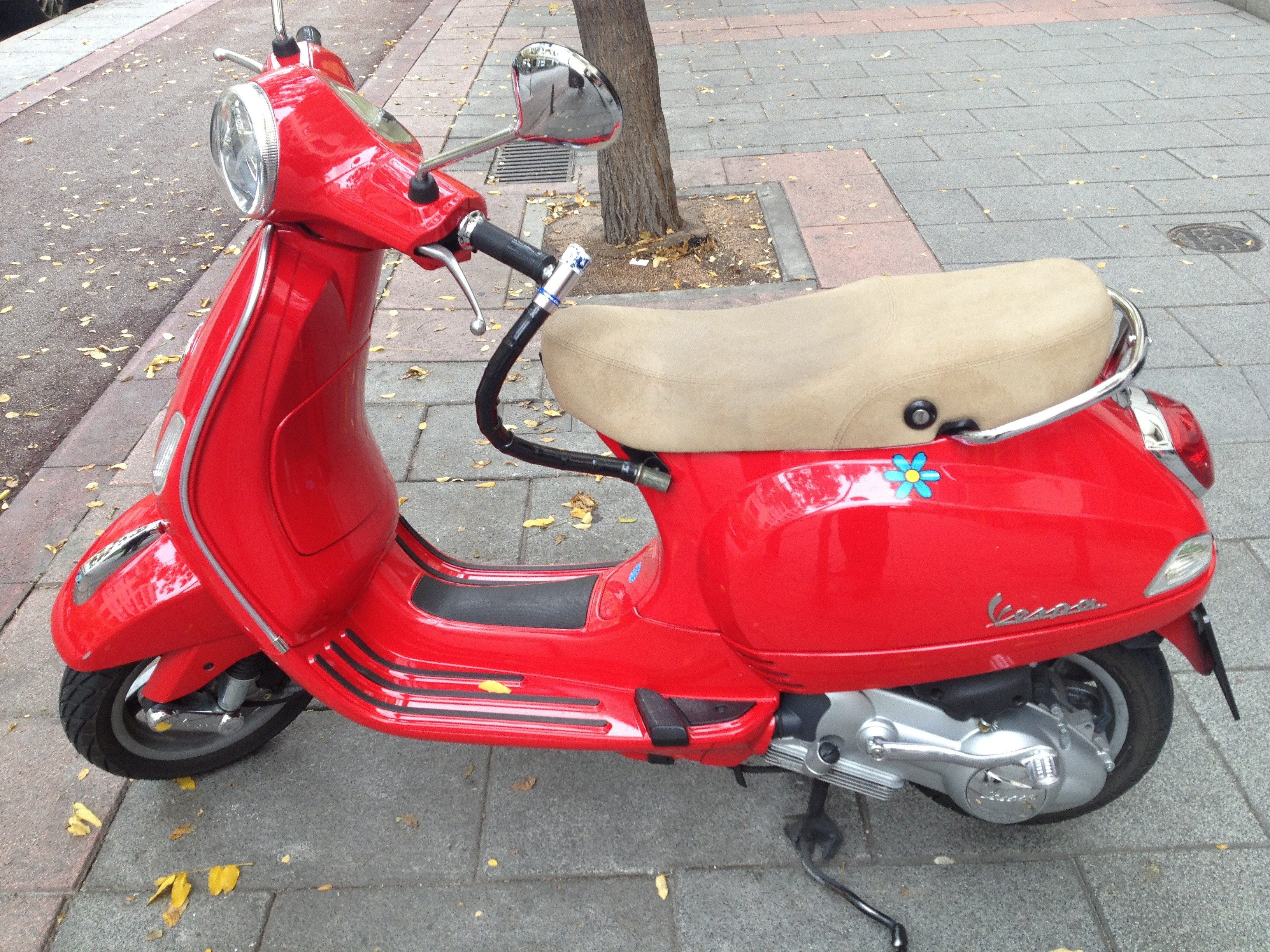 red vespa  park on the street