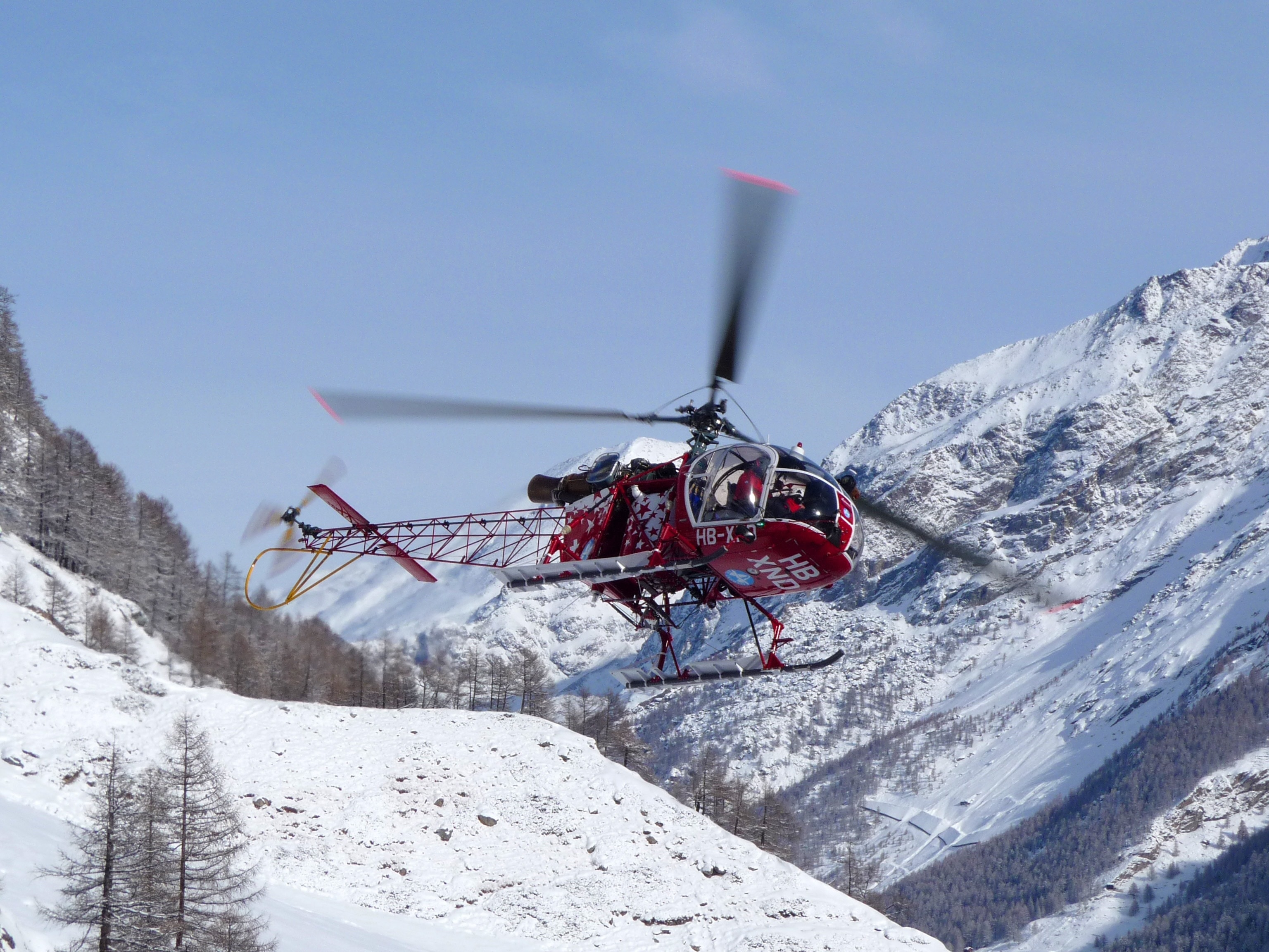 red and black helicopter near glacier mountain