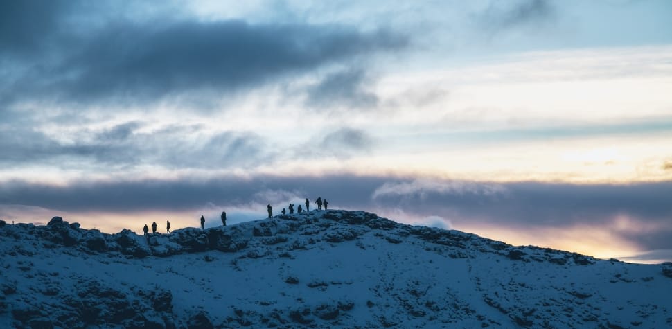 group of person on top of snow covered mountain preview