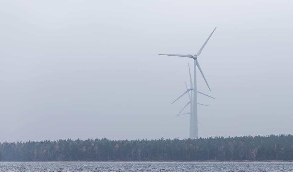 white windmills under gray cloudy sky during daytime preview