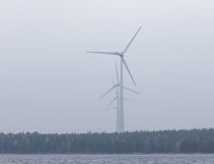 white windmills under gray cloudy sky during daytime thumbnail