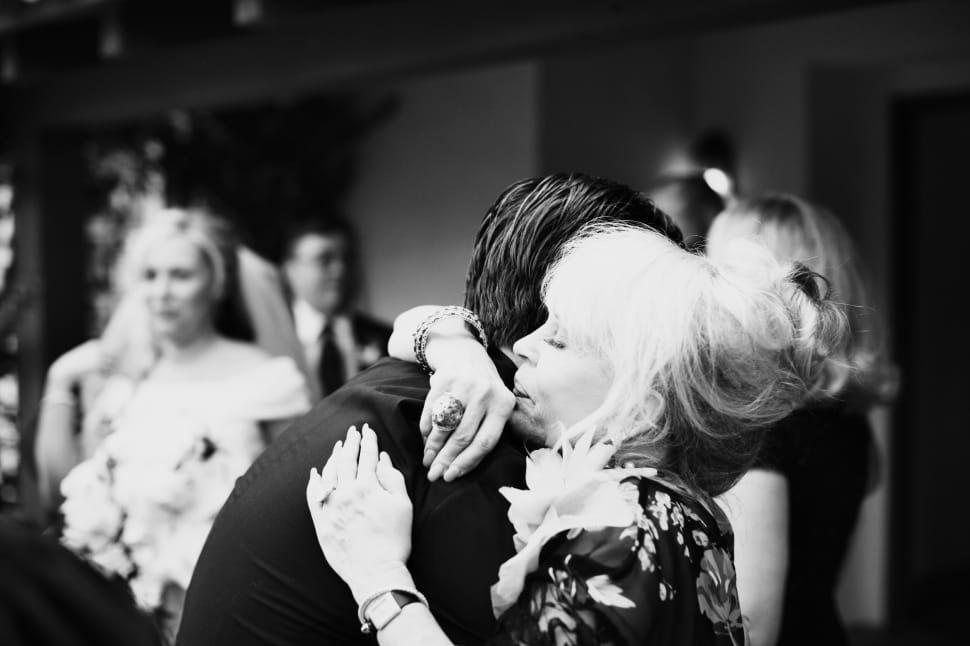 grayscale photography of man hugged woman preview