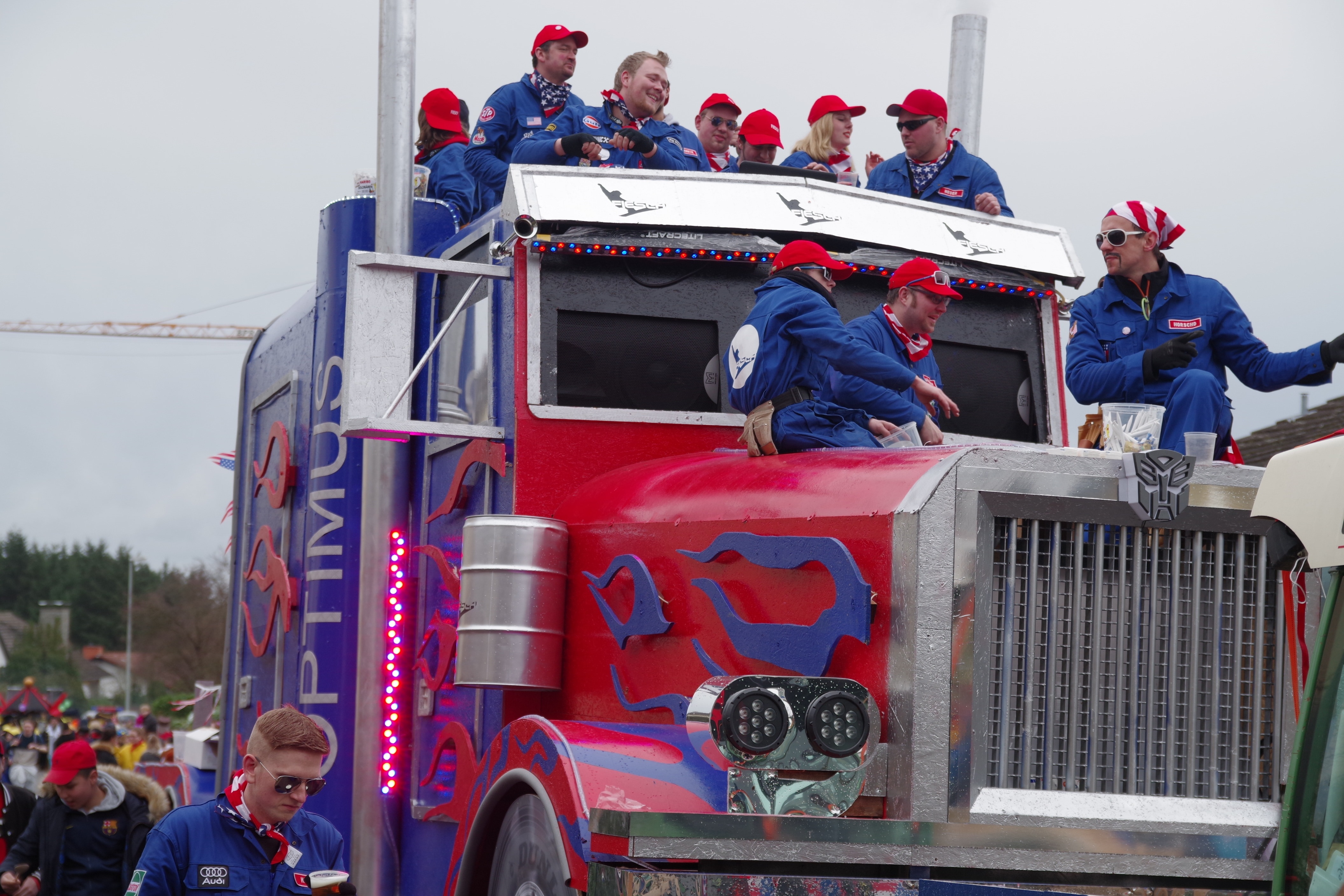 group of people riding on top of red Optimus Prime
