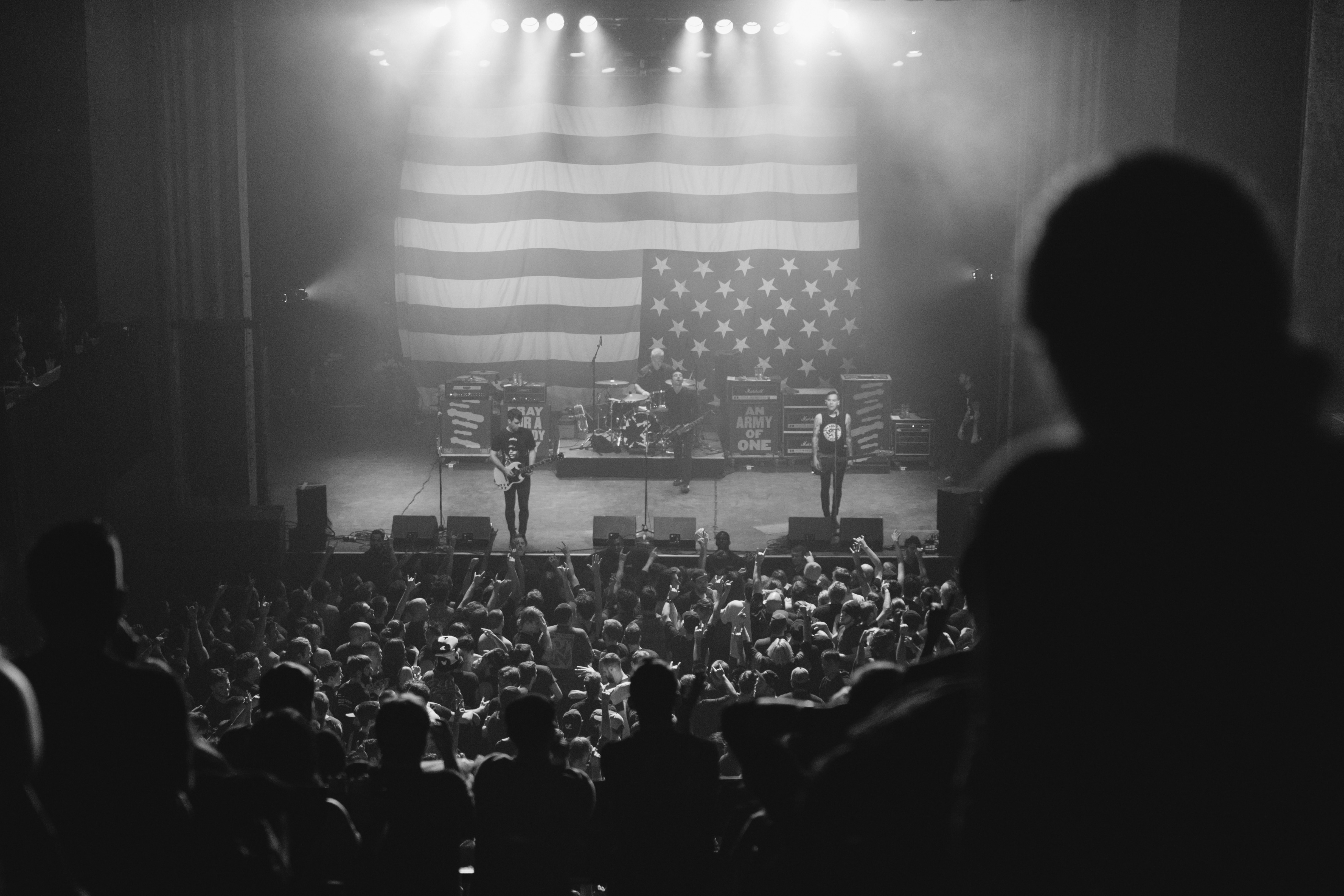 photo of live concert with united states of america flag gray scale photography