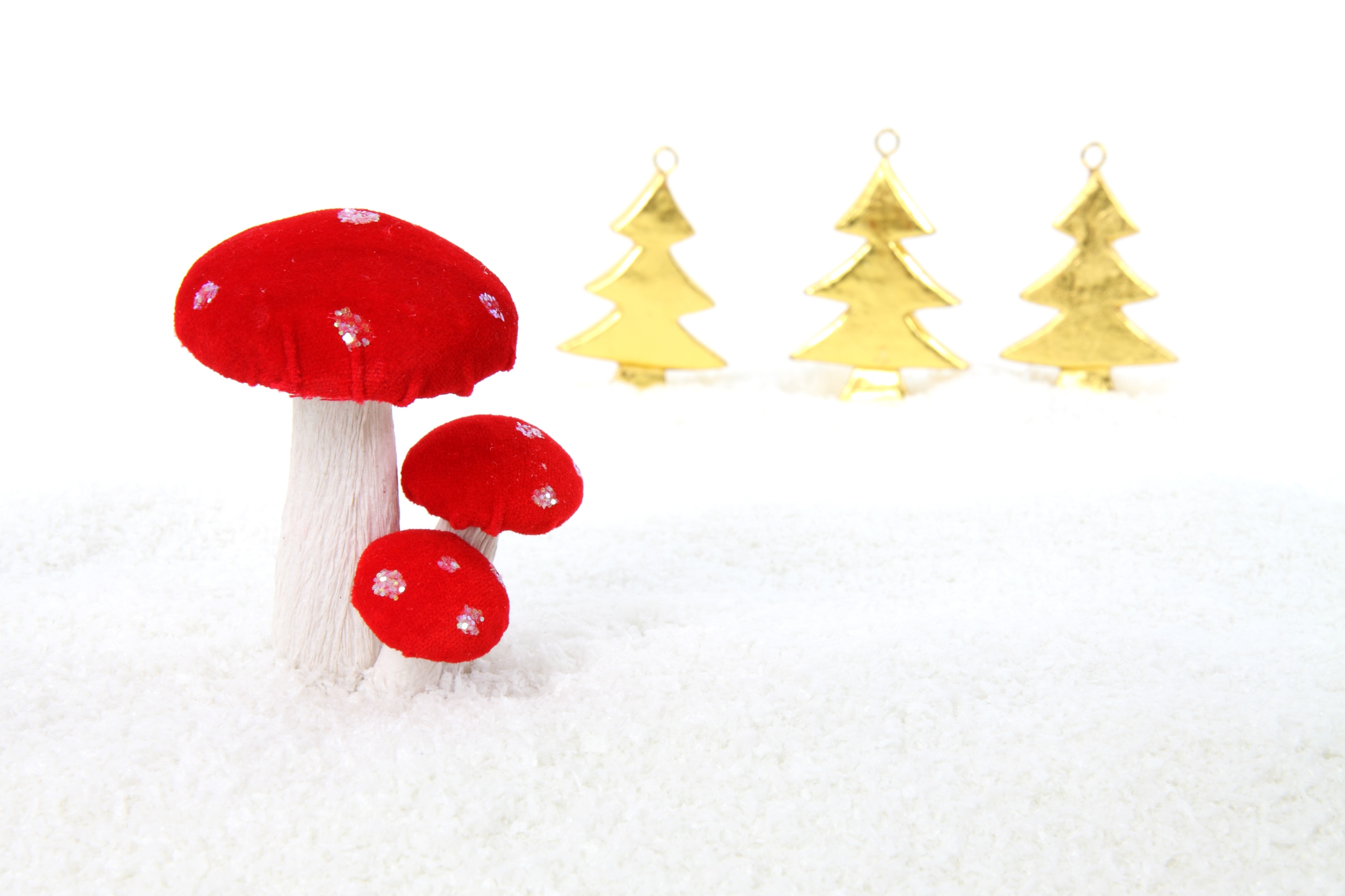 red mushroom and 3 gold tree ornaments
