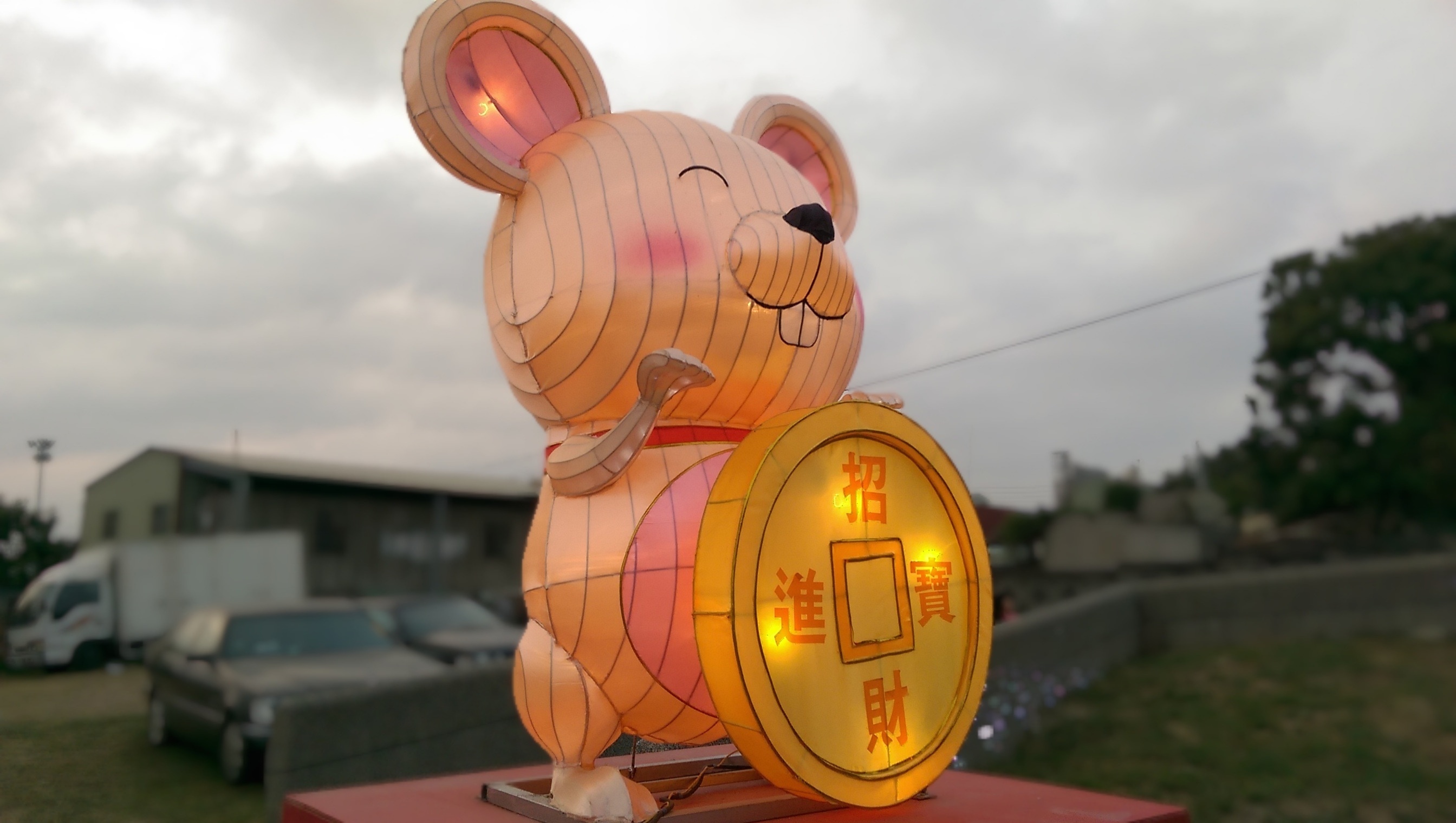brown and black mouse with fortune coin statue