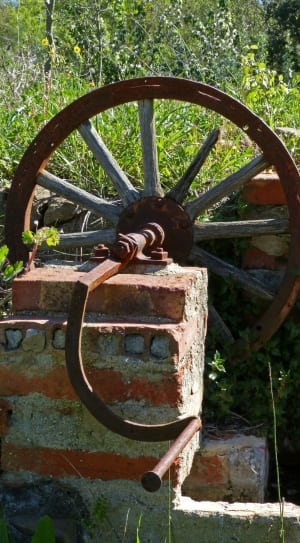 brown metal wheel near gray concrete bricks thumbnail