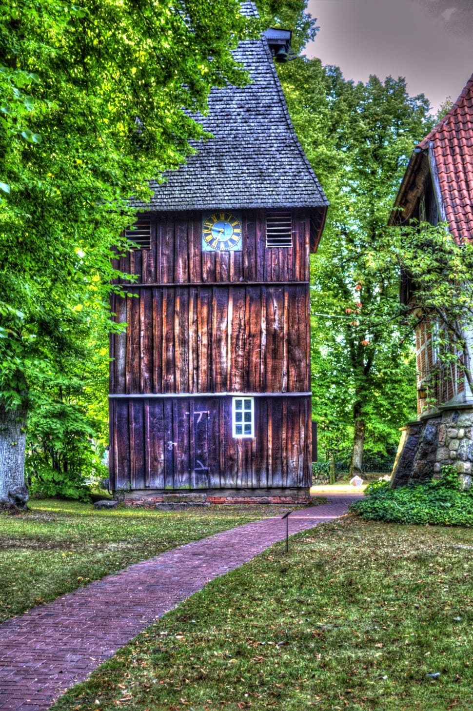 photo of brown wooden house near the trees and grass field preview