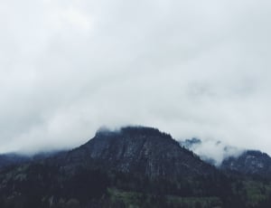 grey high rise mountain with clouds thumbnail