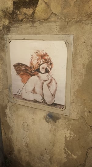 white wooden frame cherub in goggles painting thumbnail